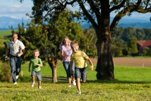 11193734-happy-family-outdoors-is-running-on-a-meadow-on-a-beautiful-summer-day--they-try-to-catch-each-other